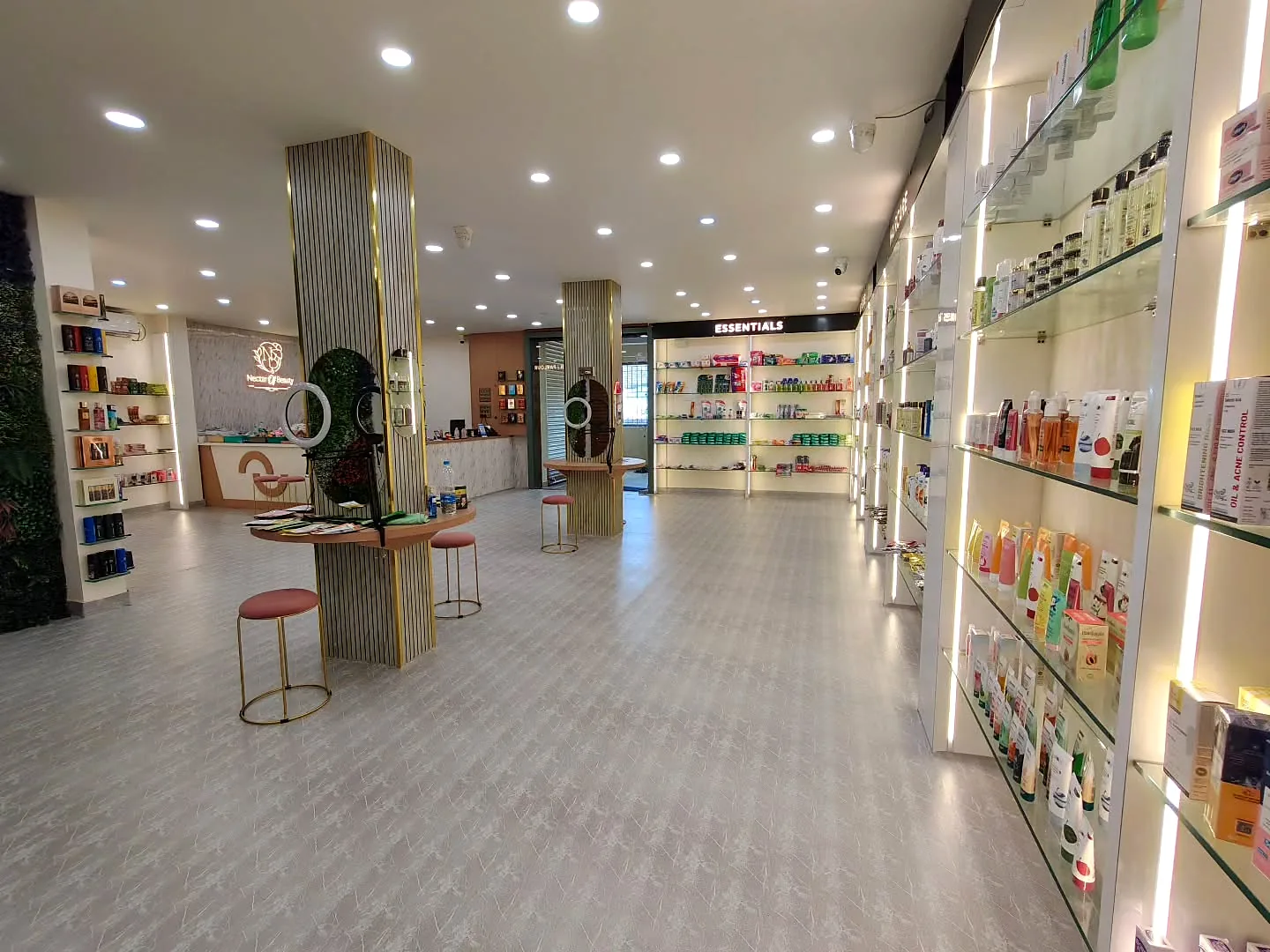 Wide view of the store with pillars, mirror stations and the logo wall