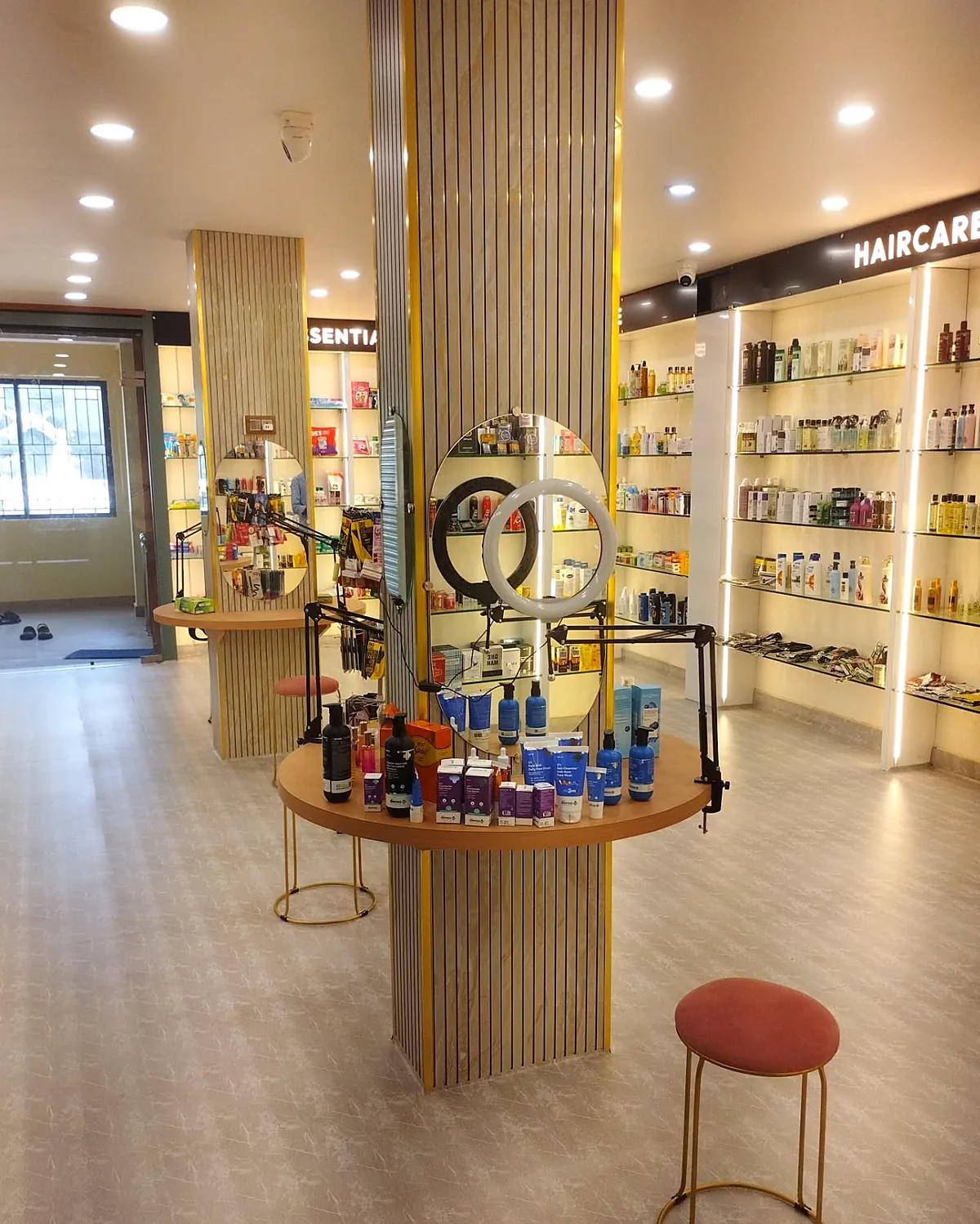 Round mirror station with ring light and products on the table